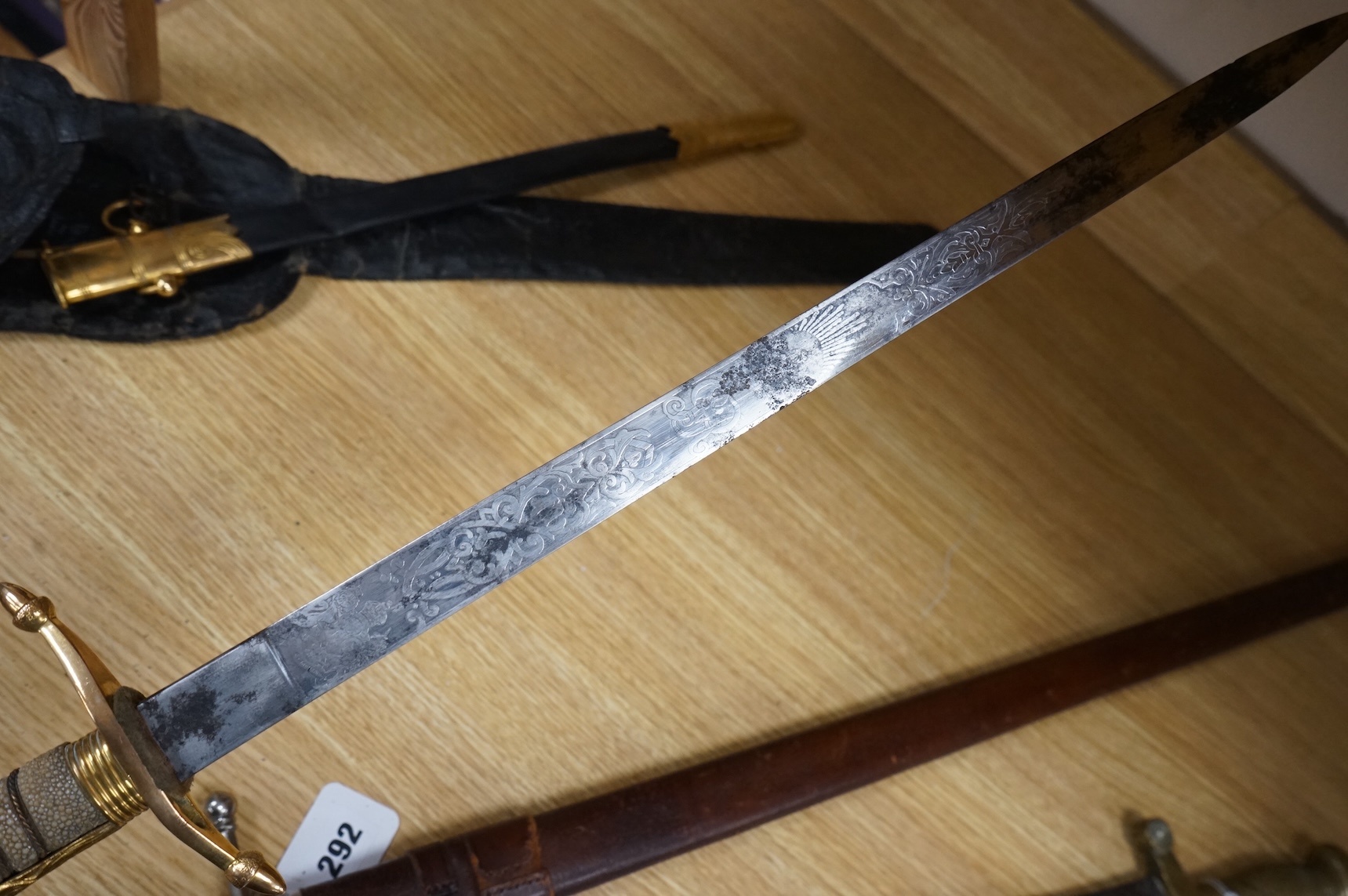 A post 1902 regulation Naval Officer’s dirk with lion’s head pommel, bullion dress knot, shark skin covered grip, in its leather scabbard, the gilt locket engraved with owners initials; CHCO’ R, the blade etched with cro